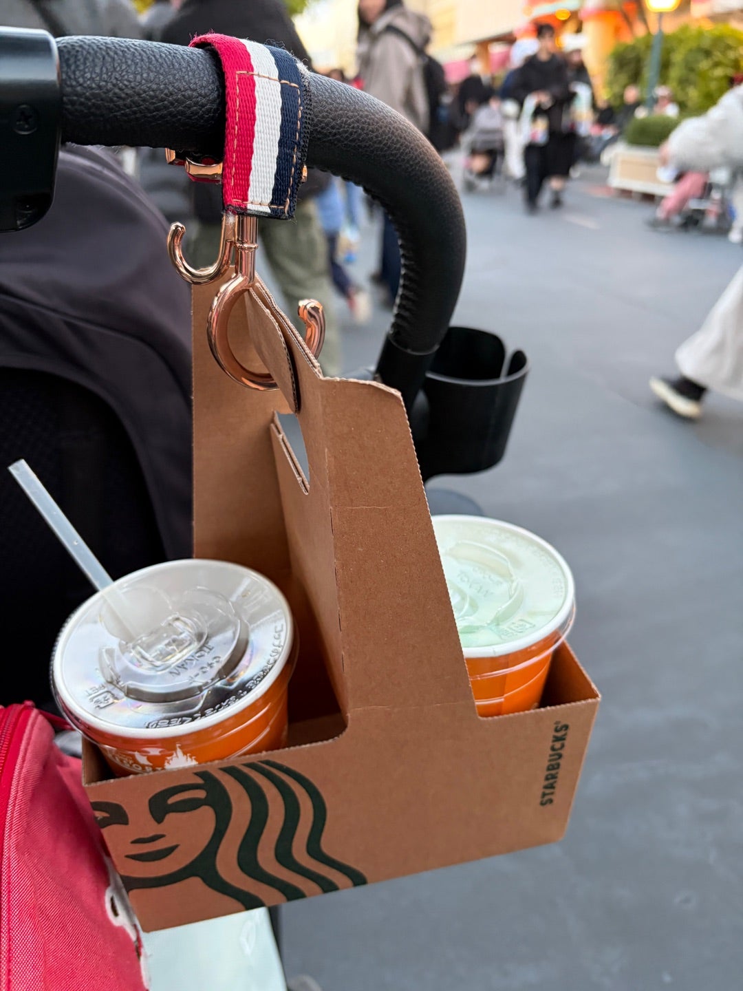 Cardboard drinks carrier used on a pushchair to carry free drinks